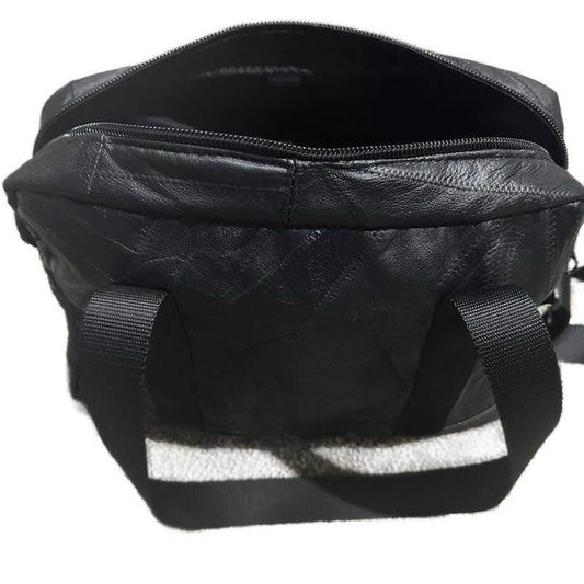 Black Leather Shoulder Bag with Reflective Stripes and Adjustable Straps.